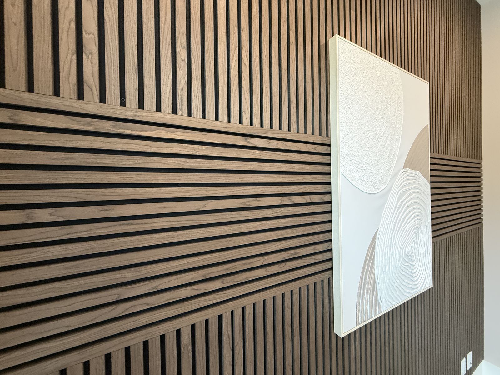 Signature walnut slat detail with sculptural panel